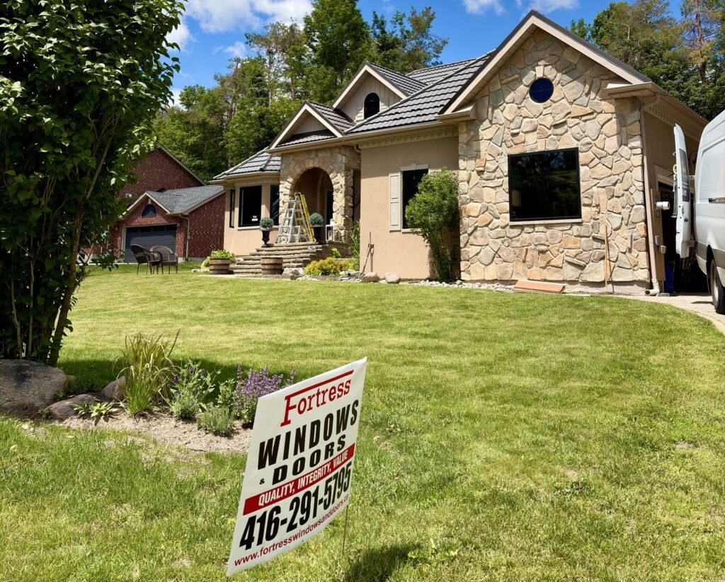 Oro-Medonte home with steel roof, new windows, stone front and Fortress Windows & Doors lawn sign